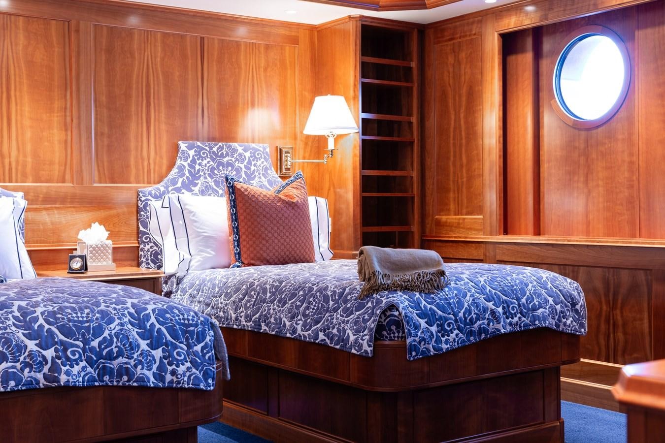 a bed with a blue comforter aboard CUPANI Yacht for Sale