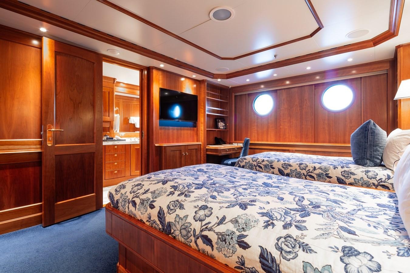 a bedroom with a bed and a television aboard CUPANI Yacht for Sale