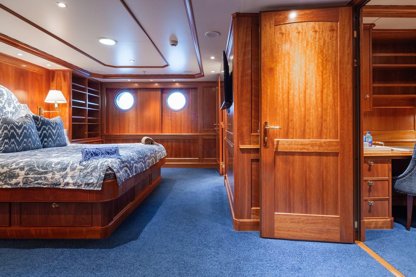 a bedroom with a bed and a closet aboard CUPANI Yacht for Sale