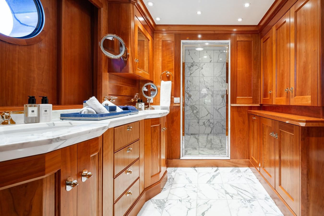 a bathroom with wooden cabinets aboard CUPANI Yacht for Sale