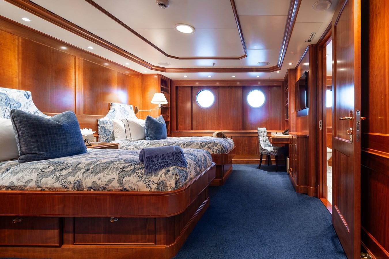 a room with a bed and a chair aboard CUPANI Yacht for Sale