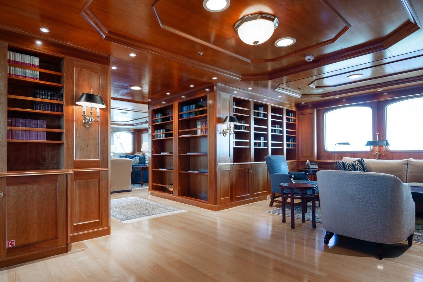 a living room with a book shelf aboard CUPANI Yacht for Sale
