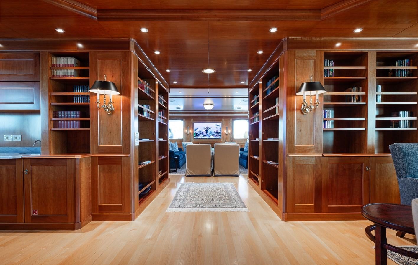 a room with a wood floor and a bookshelf aboard CUPANI Yacht for Sale