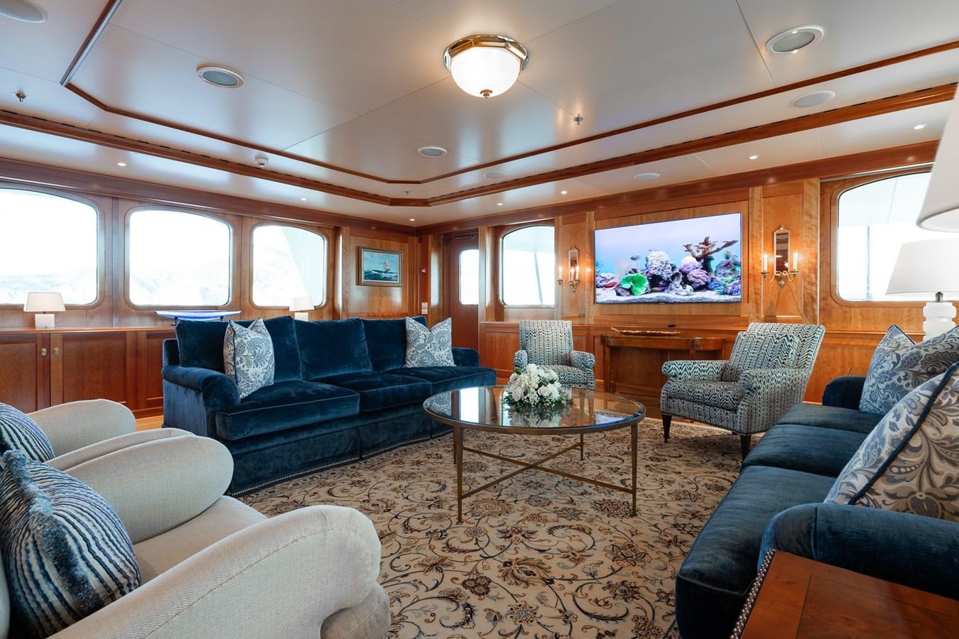 a living room with a large screen aboard CUPANI Yacht for Sale