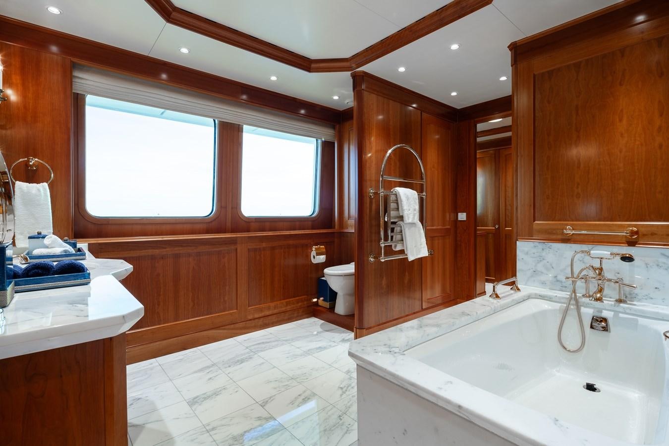 a bathroom with a tub sink and toilet aboard CUPANI Yacht for Sale