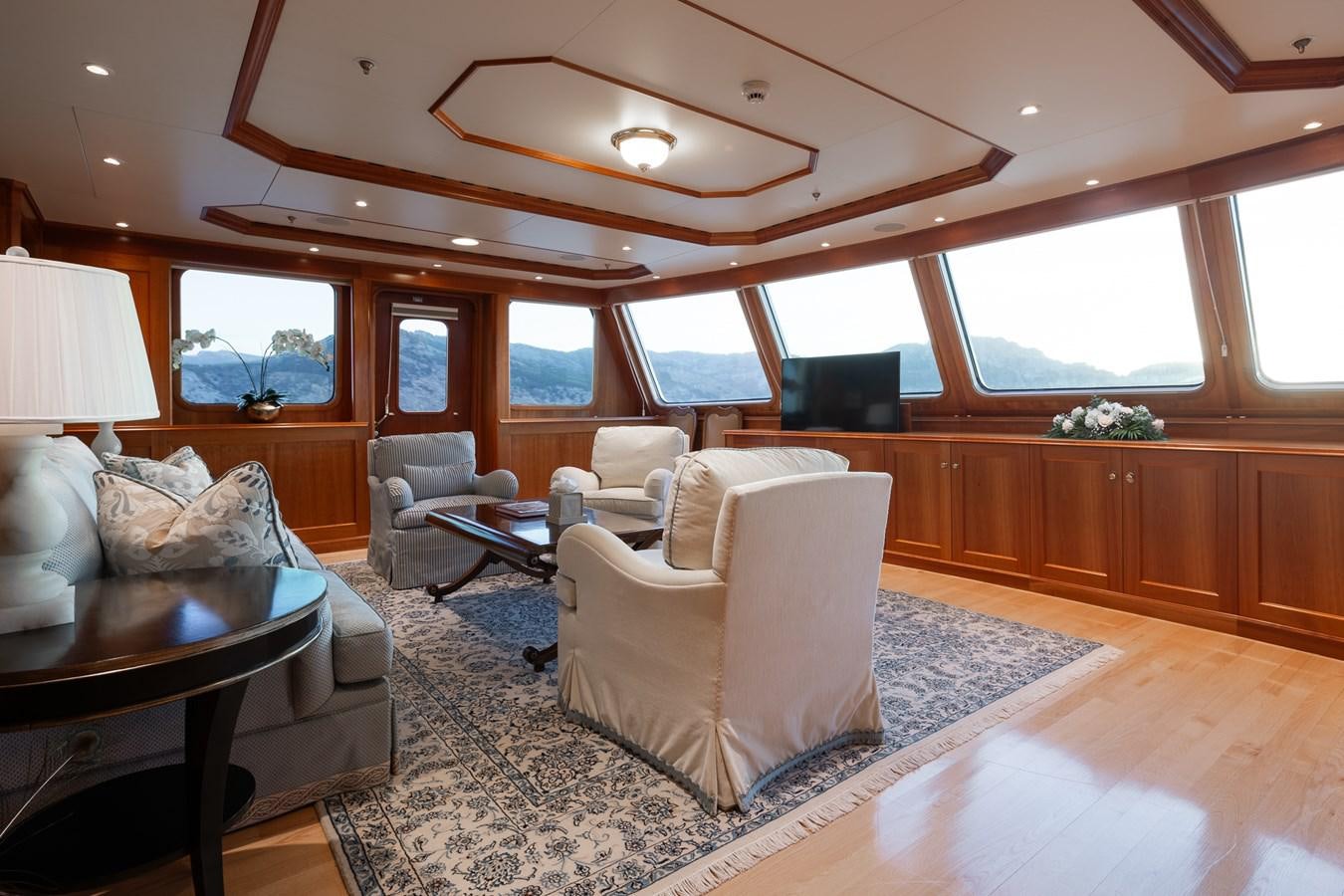 a living room with a large window aboard CUPANI Yacht for Sale