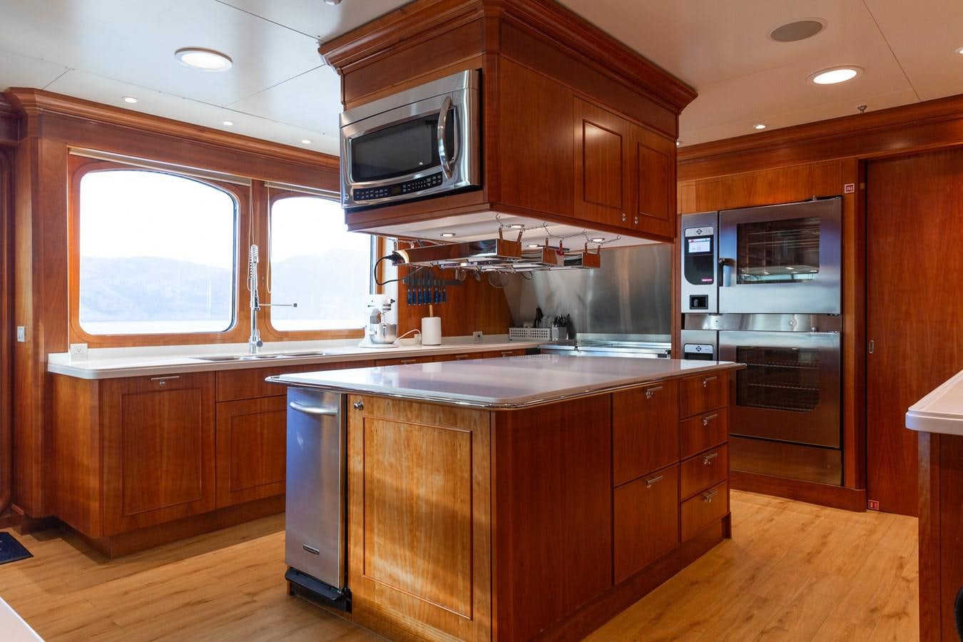 a kitchen with wooden cabinets aboard CUPANI Yacht for Sale