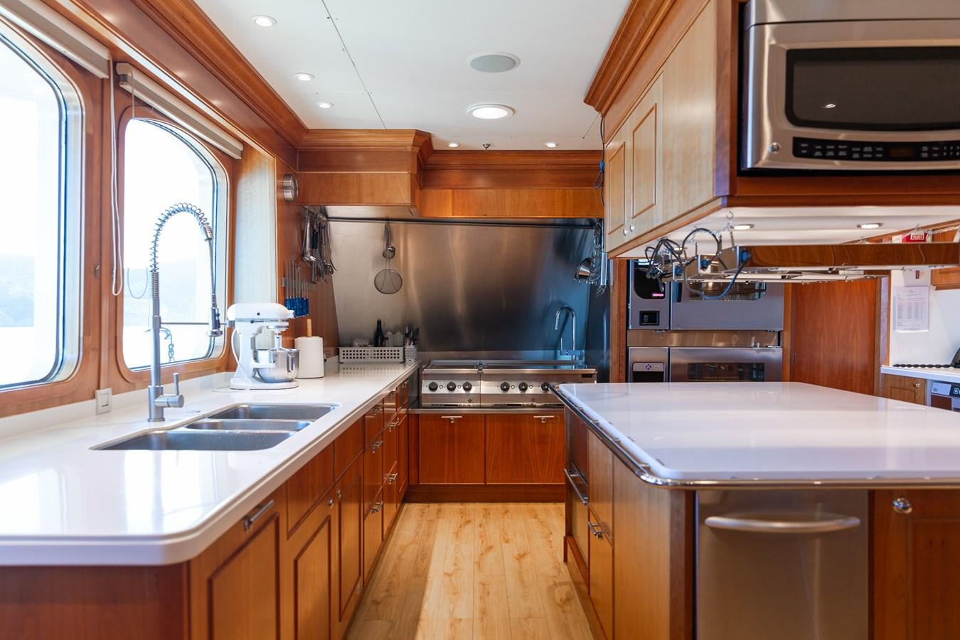 a kitchen with wooden cabinets aboard CUPANI Yacht for Sale