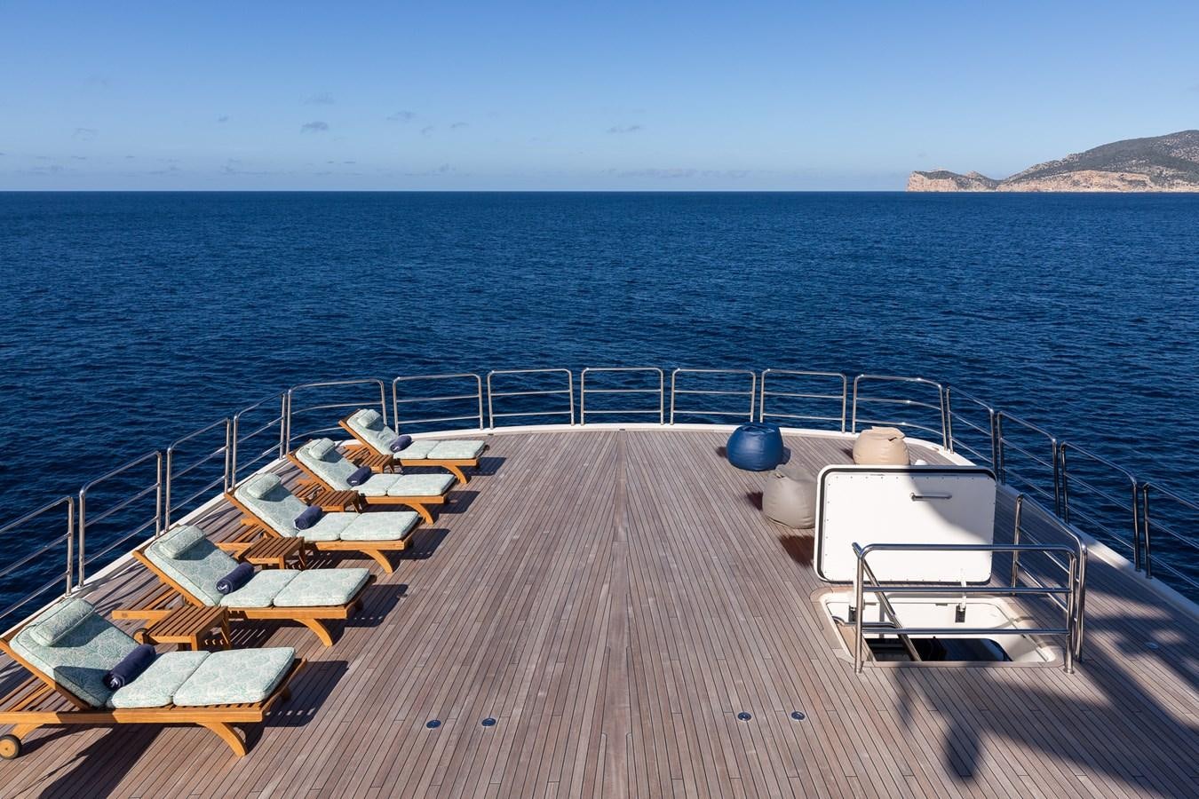 a deck with chairs on it by the water aboard CUPANI Yacht for Sale