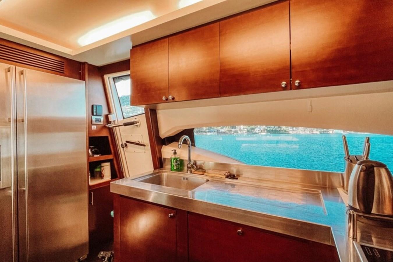 a kitchen with a large blue swimming pool aboard C Yacht for Sale