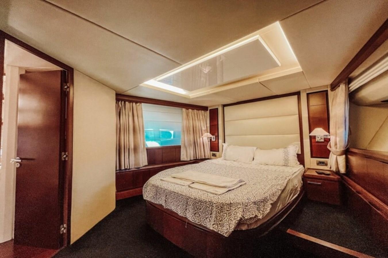 a bedroom with a bed and a window aboard C Yacht for Sale