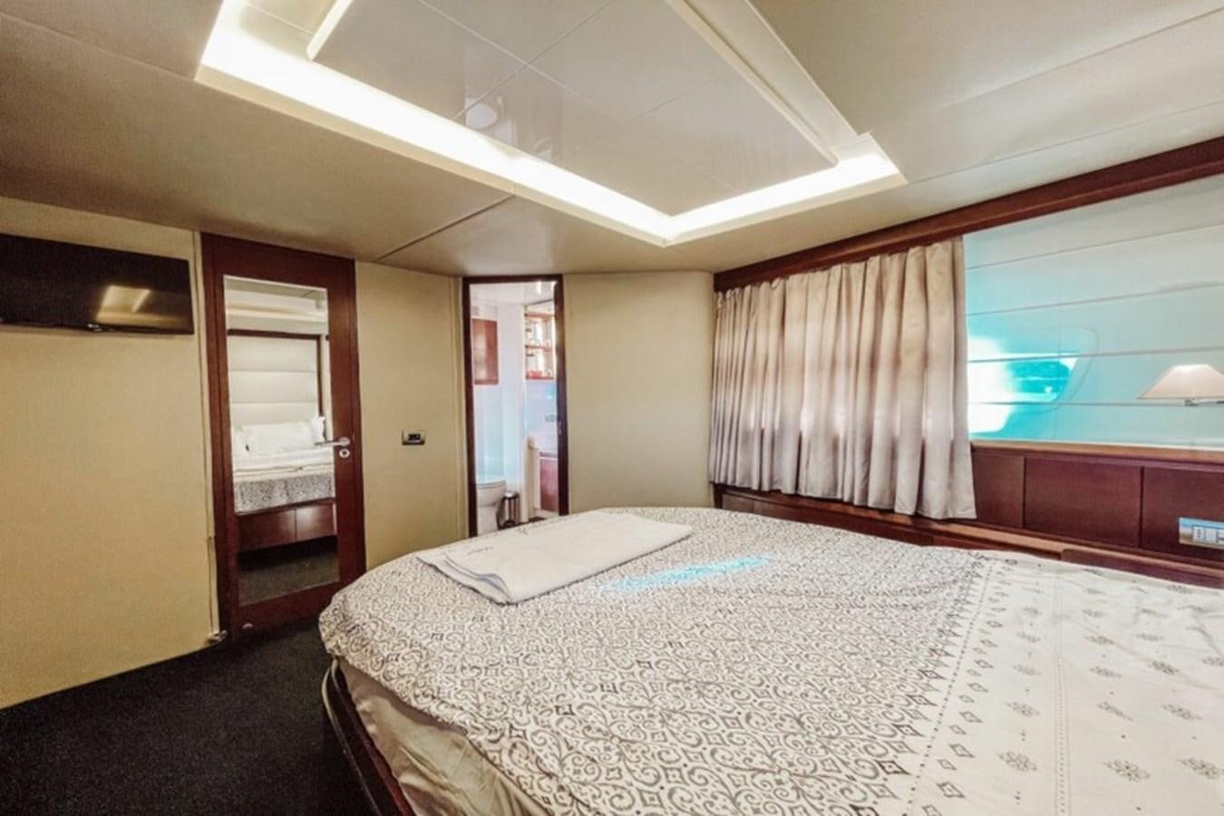 a bedroom with a bed and a mirror aboard C Yacht for Sale