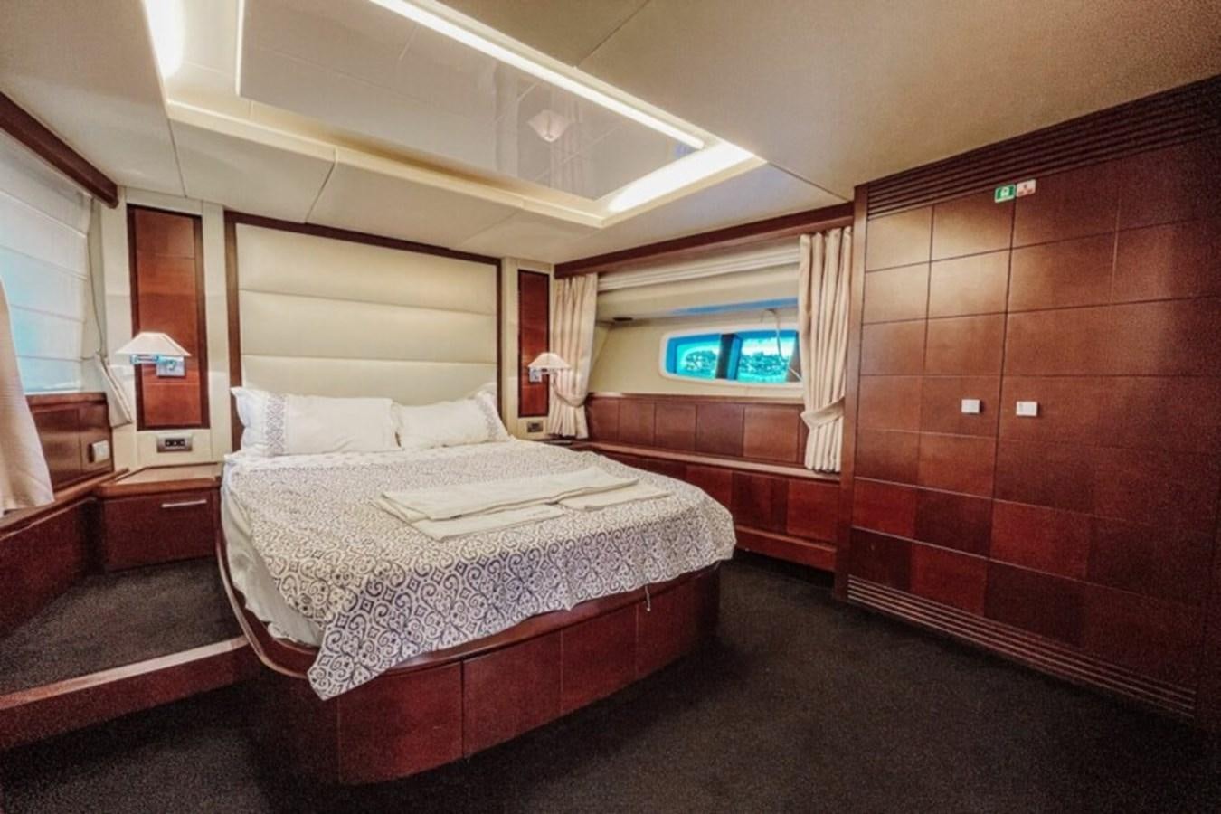 a room with a bed and a window aboard C Yacht for Sale