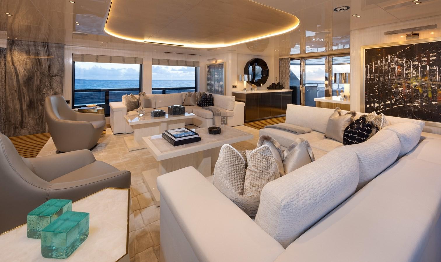 a living room with a large screen aboard ANCORA Yacht for Sale