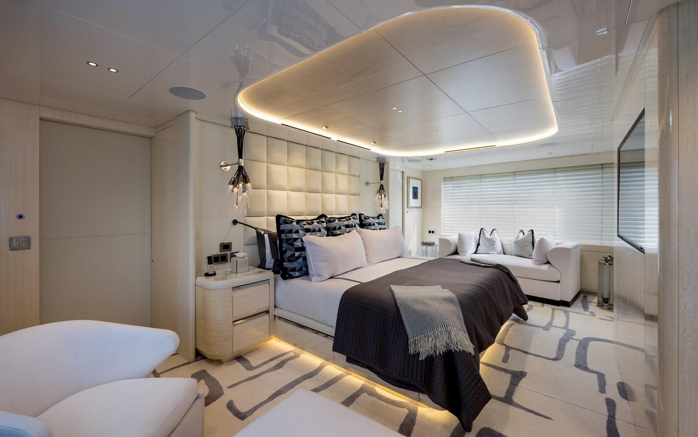 a room with a bed and a chandelier aboard ANCORA Yacht for Sale