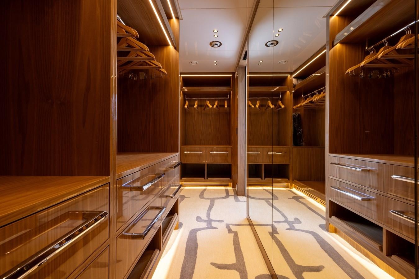 a large room with wooden cabinets aboard ANCORA Yacht for Sale