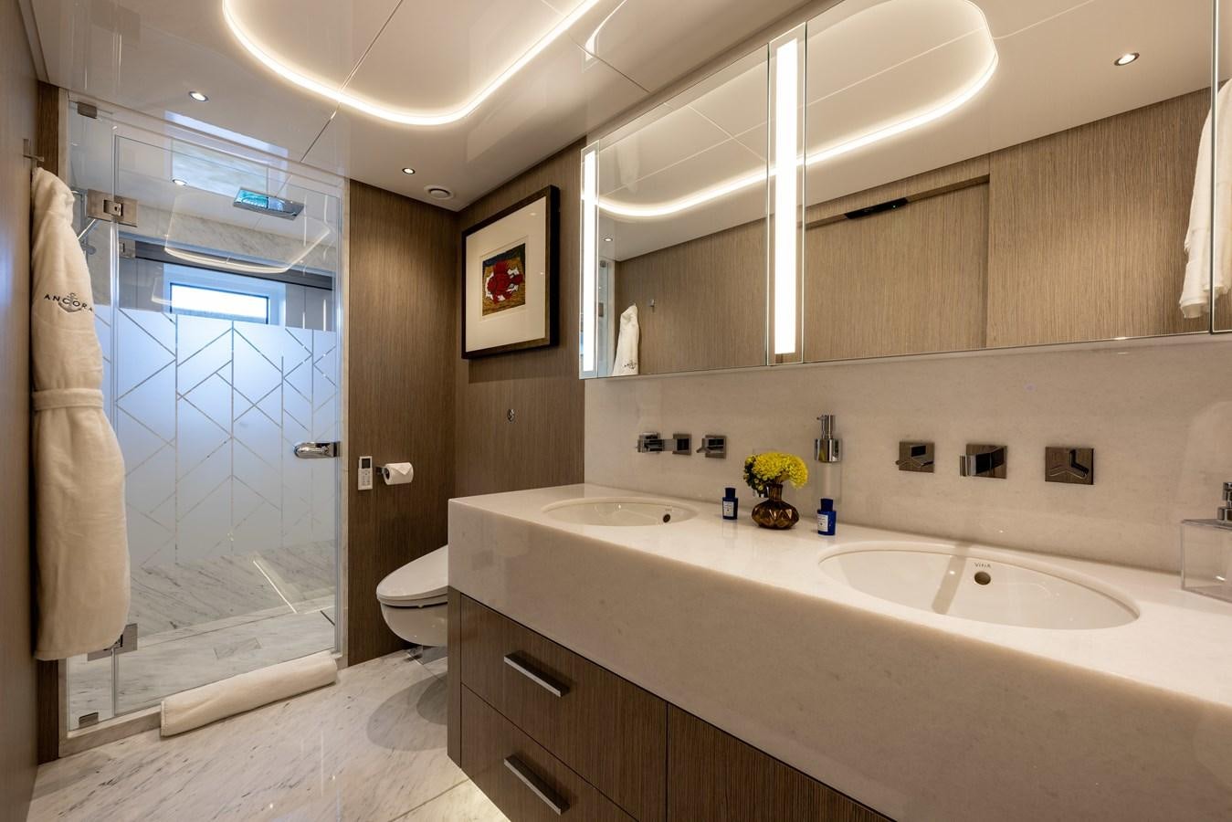 a bathroom with a glass shower door aboard ANCORA Yacht for Sale
