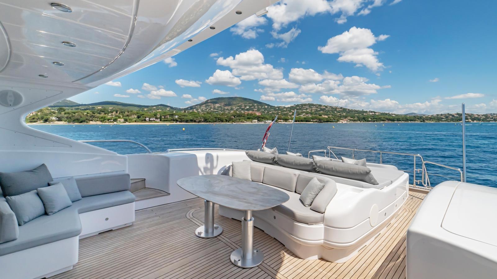 a room with a bed and a table on a boat aboard COSMOS Yacht for Sale