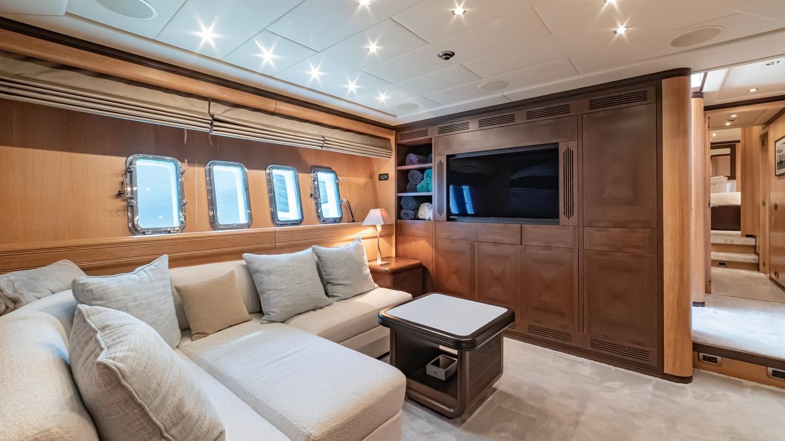 a room with a couch and a television aboard COSMOS Yacht for Sale