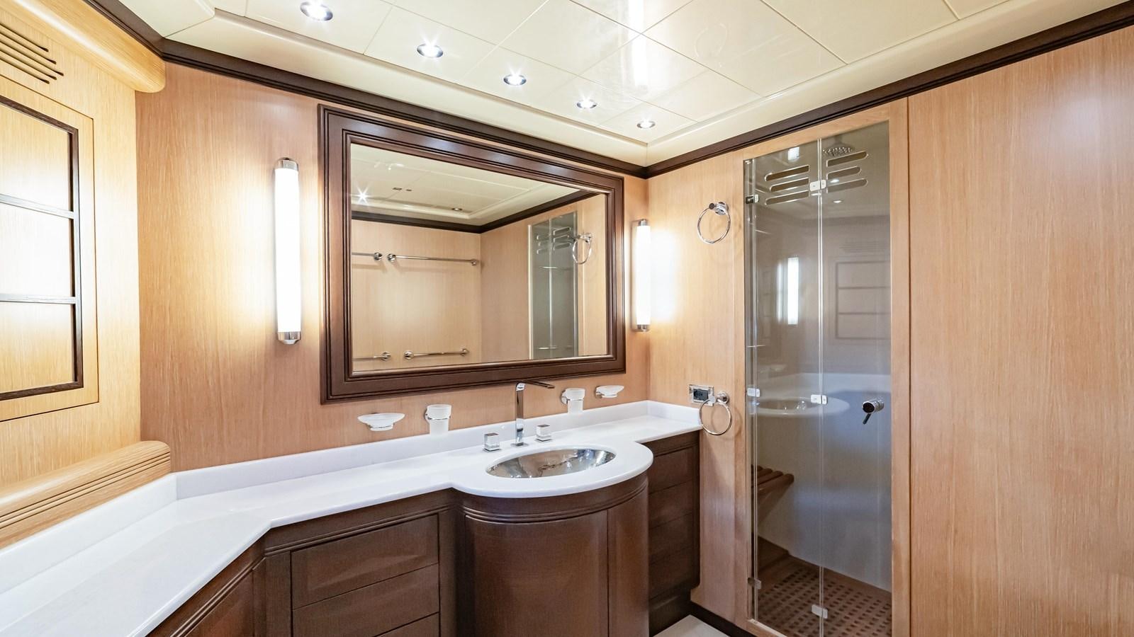 a bathroom with a large mirror aboard COSMOS Yacht for Sale