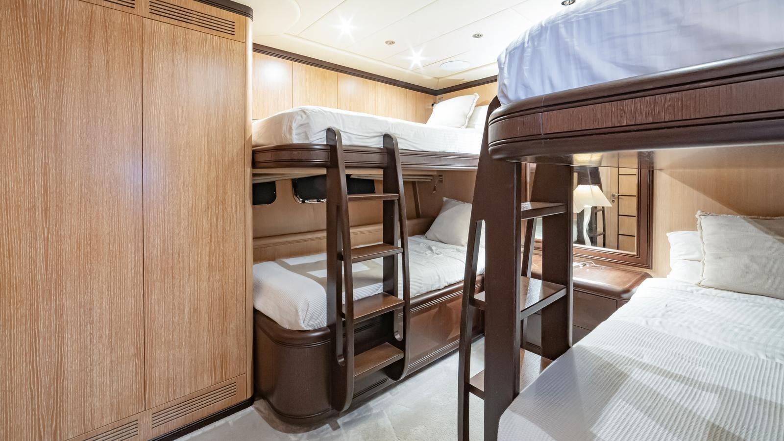 a room with bunk beds aboard COSMOS Yacht for Sale