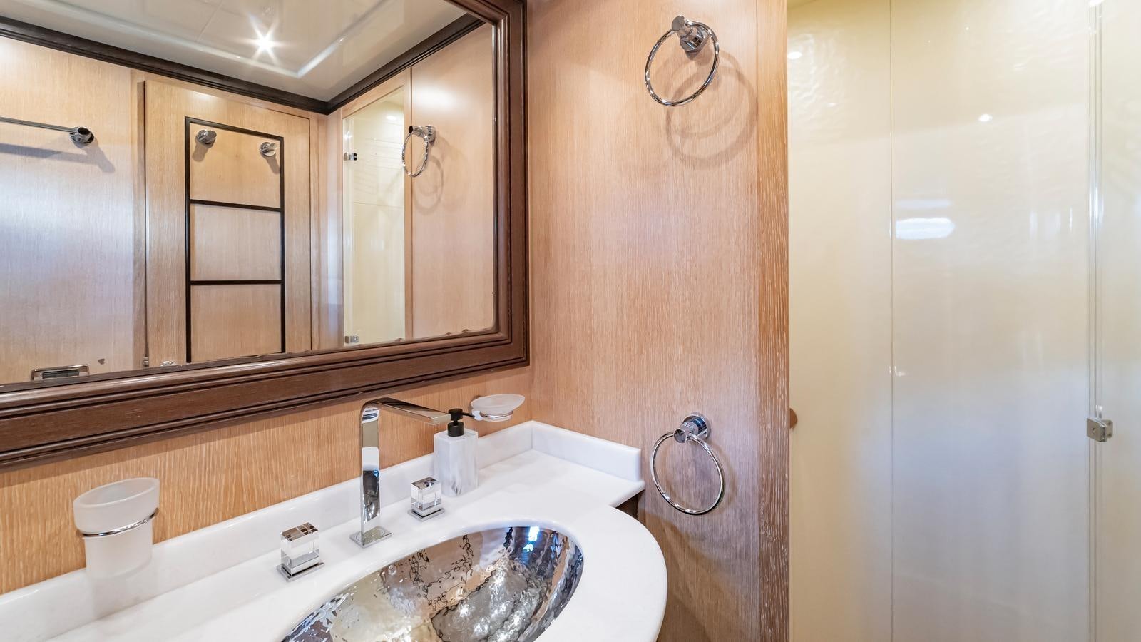 a bathroom with a large mirror aboard COSMOS Yacht for Sale