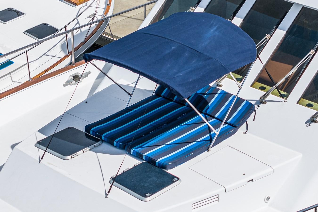 a blue umbrella on a white surface aboard NIRVANA Yacht for Sale