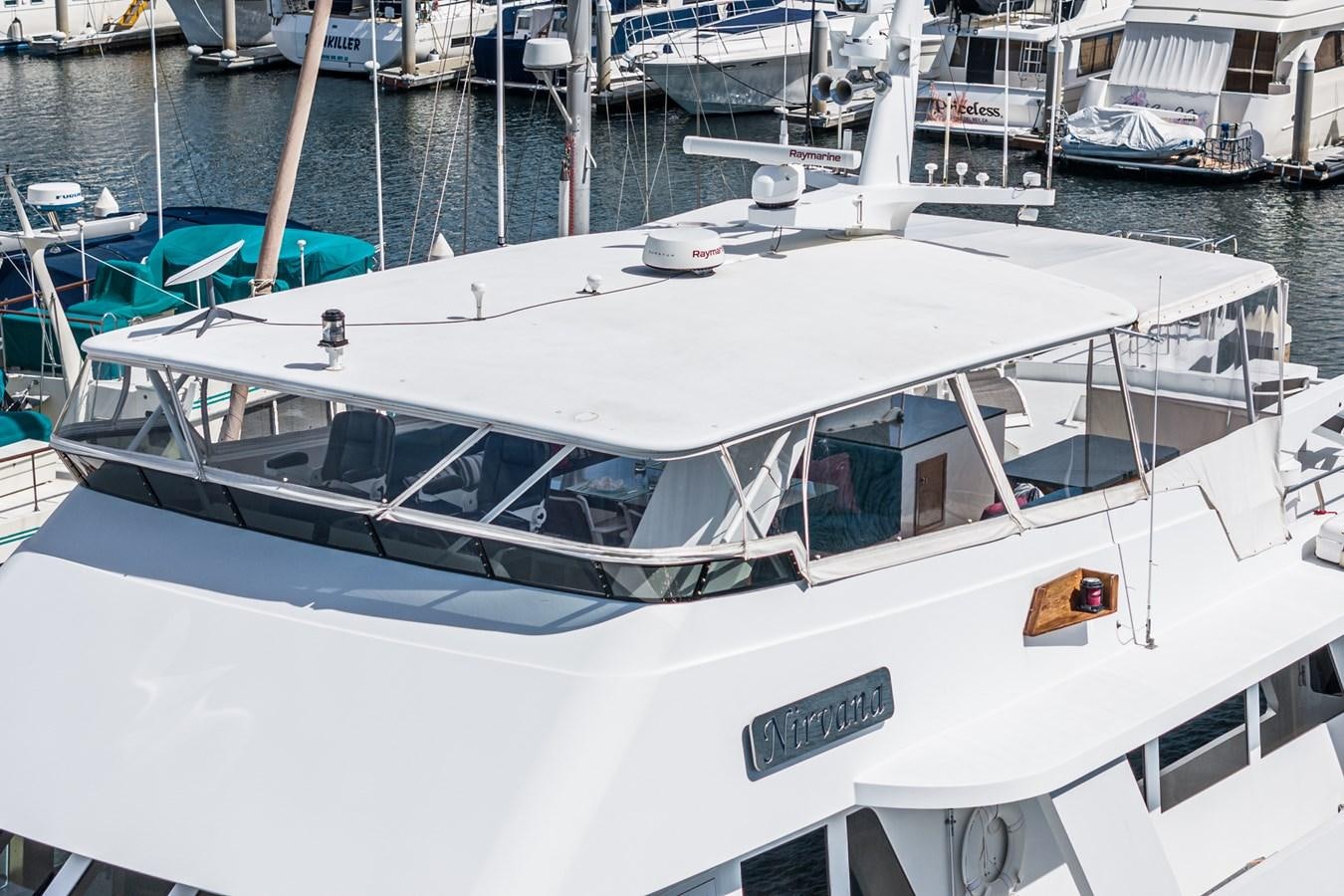 a white boat in a harbor aboard NIRVANA Yacht for Sale