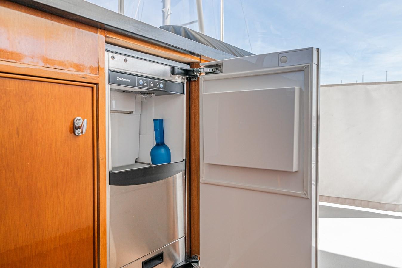 a cabinet with a door and a shelf with a blue vase on it aboard NIRVANA Yacht for Sale
