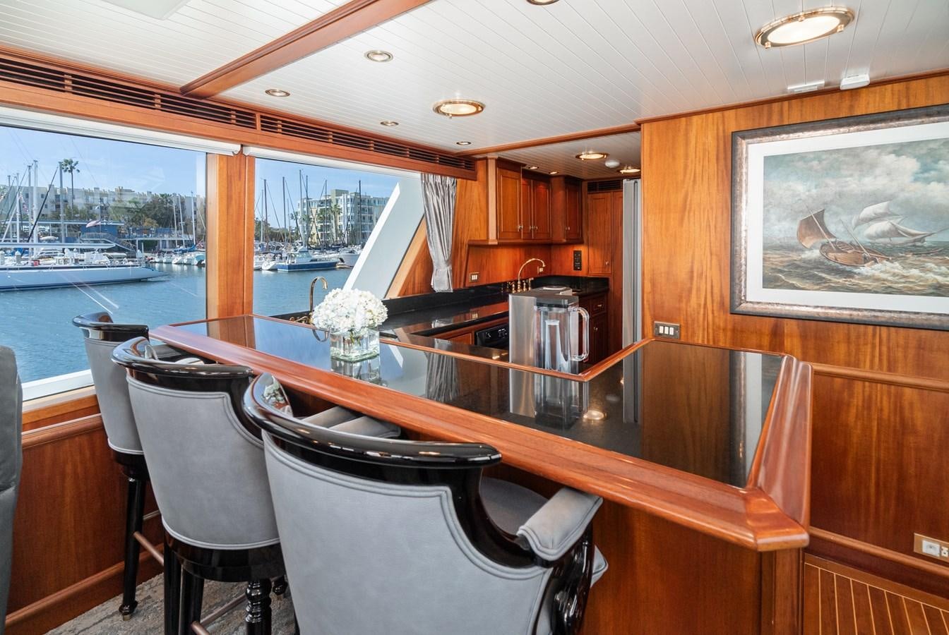 a large dining table in a wooden room aboard NIRVANA Yacht for Sale