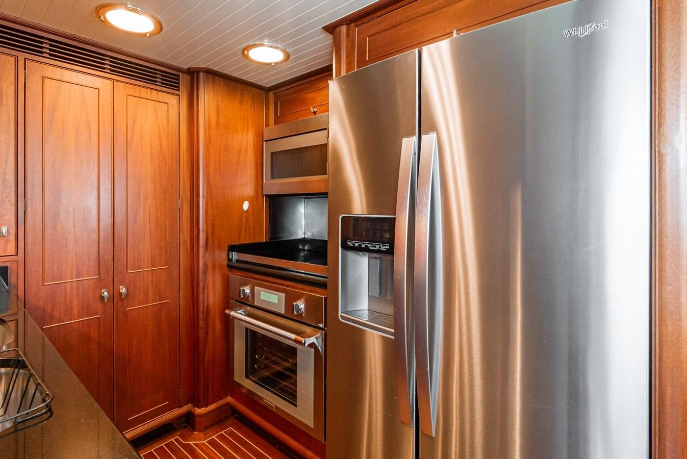 a refrigerator and microwave in a kitchen aboard NIRVANA Yacht for Sale