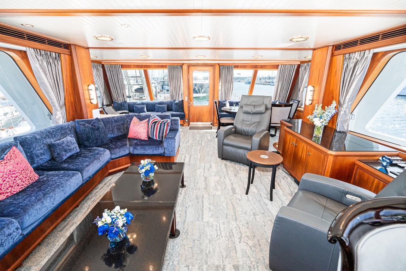 a living room with a couch and a coffee table aboard NIRVANA Yacht for Sale