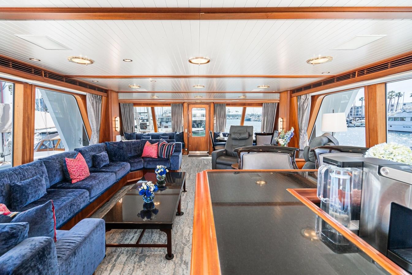a living room with a blue couch aboard NIRVANA Yacht for Sale