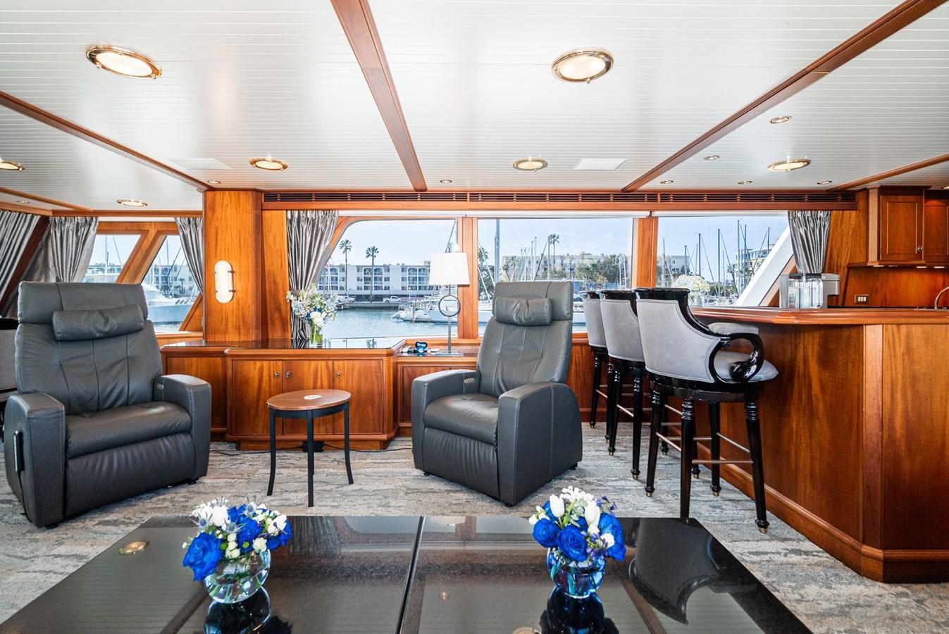 a living room with a piano and a large window aboard NIRVANA Yacht for Sale