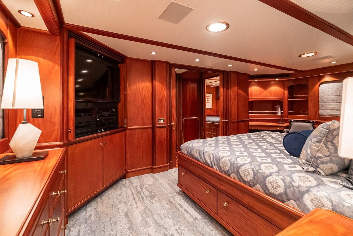 a bedroom with a bed and a dresser aboard NIRVANA Yacht for Sale