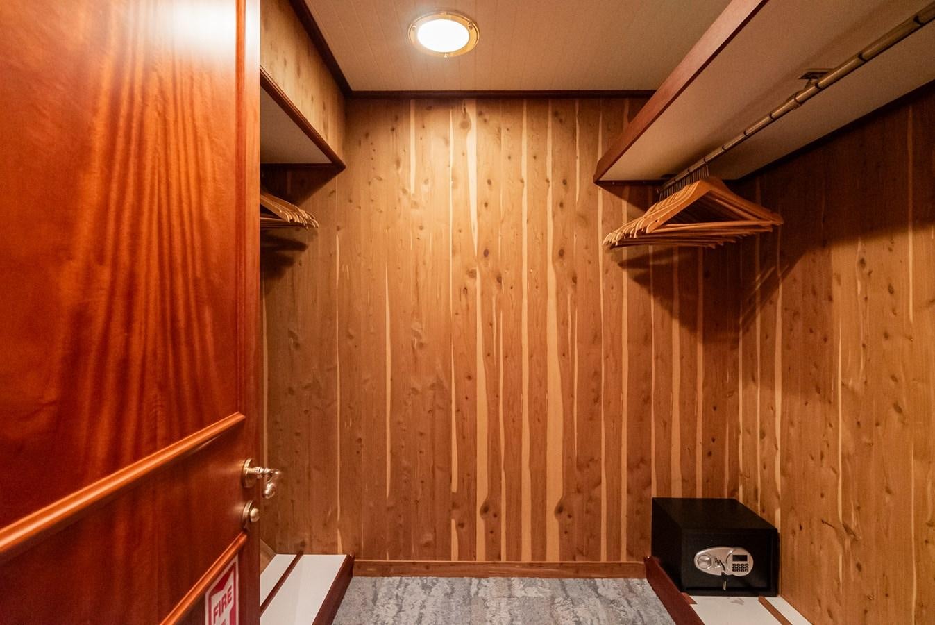 a room with a wood wall and a black box on the wall aboard NIRVANA Yacht for Sale
