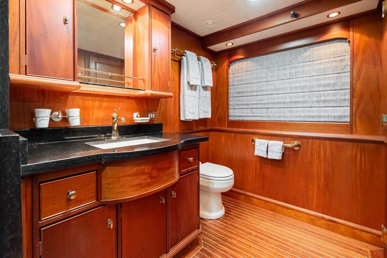 a bathroom with wooden cabinets aboard NIRVANA Yacht for Sale