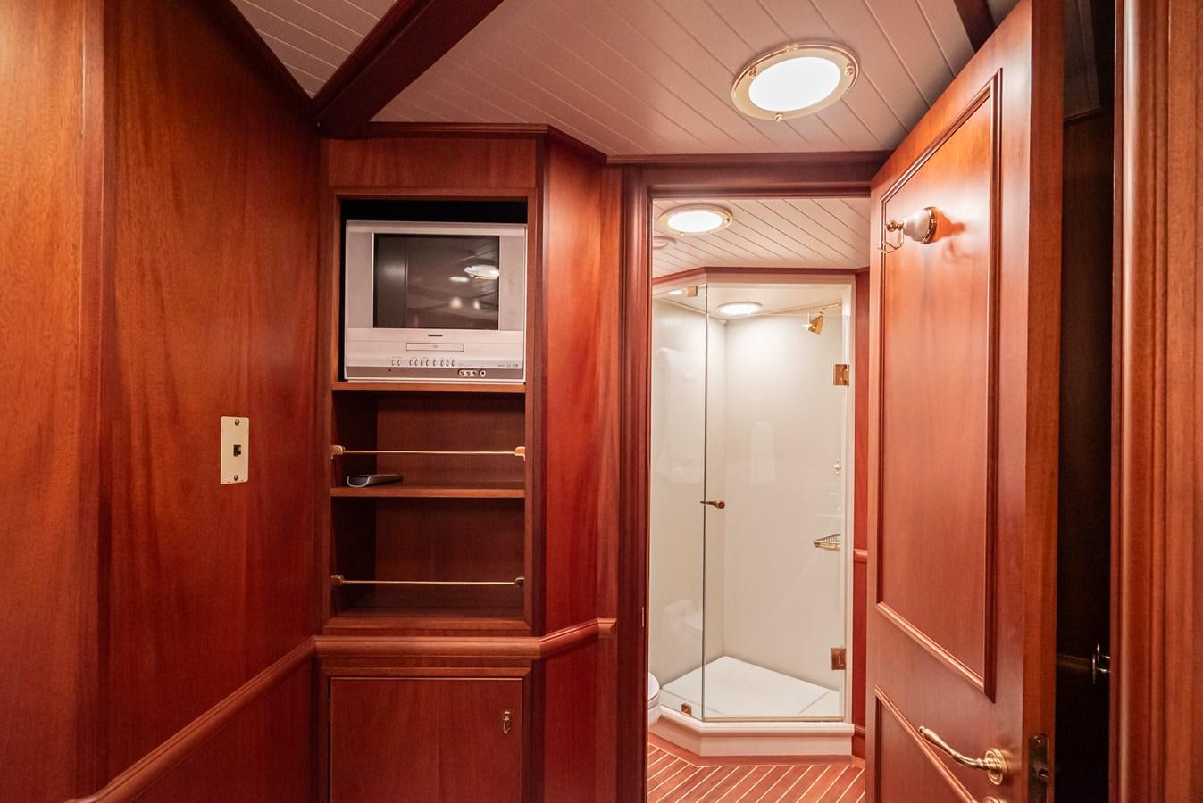 a room with a tv and a closet aboard NIRVANA Yacht for Sale