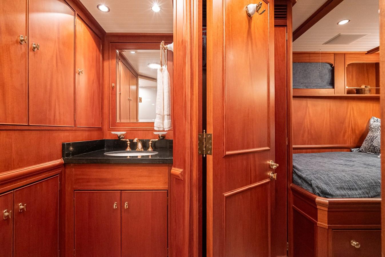 a kitchen with wooden cabinets aboard NIRVANA Yacht for Sale
