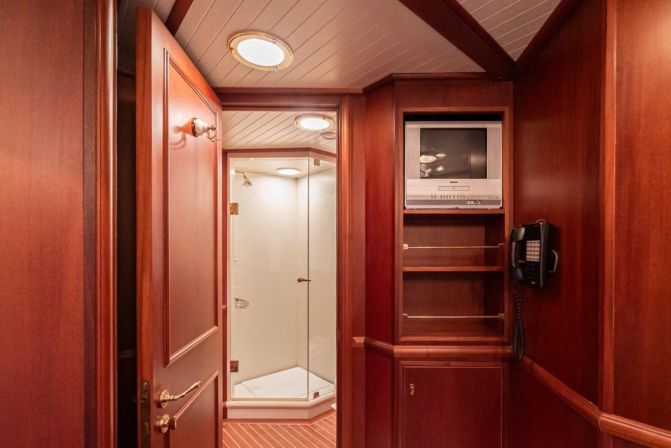 a room with a tv and a door aboard NIRVANA Yacht for Sale