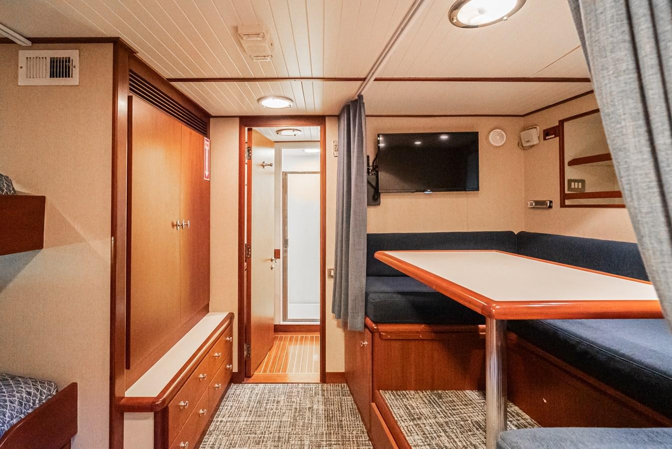a room with a bed and a television aboard NIRVANA Yacht for Sale