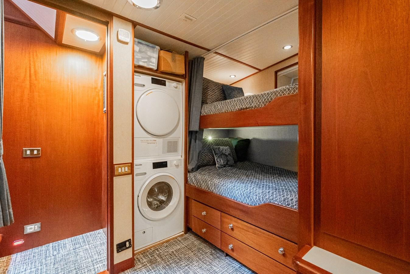 a room with a bed and a washer aboard NIRVANA Yacht for Sale