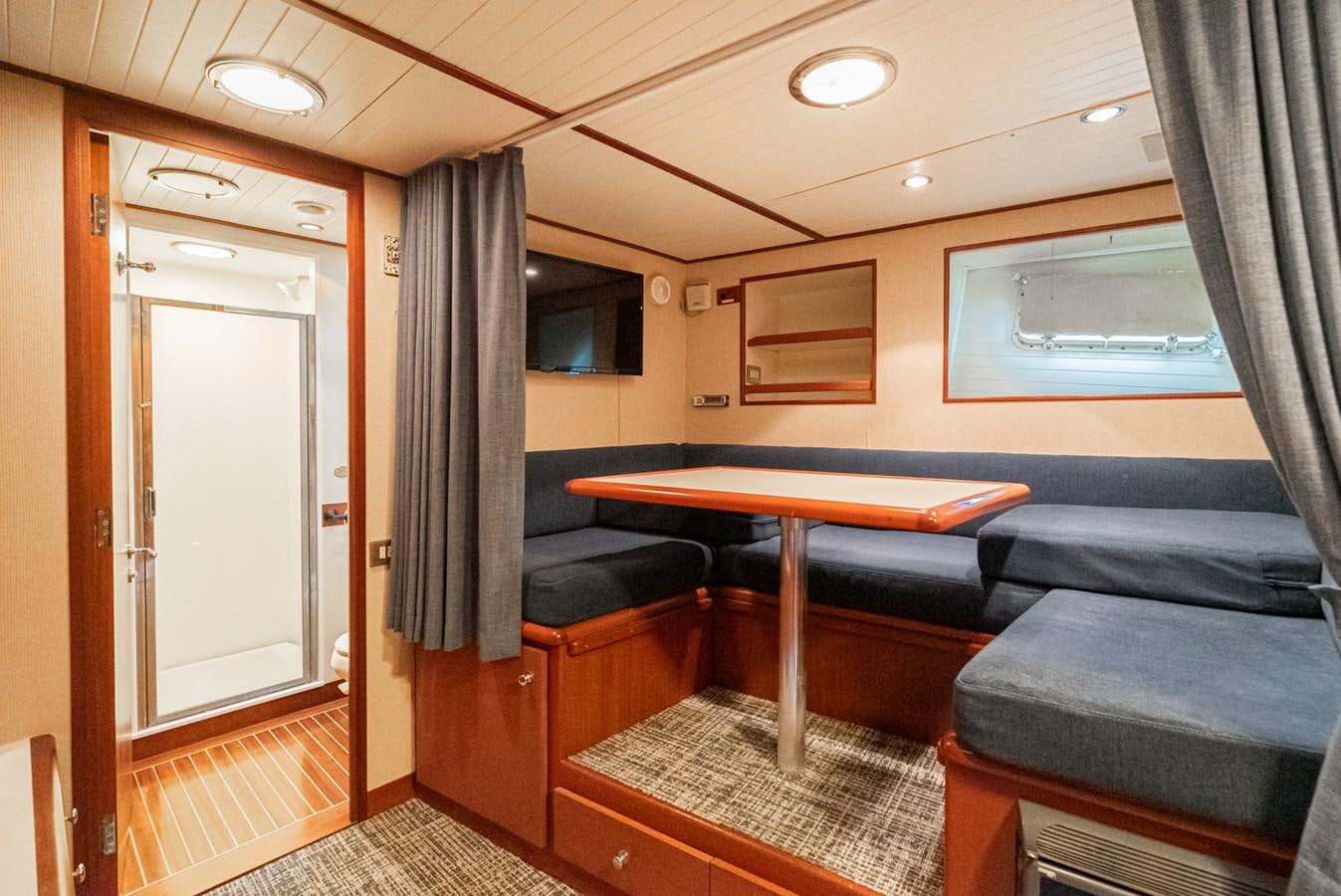 a room with a pool table and couches aboard NIRVANA Yacht for Sale