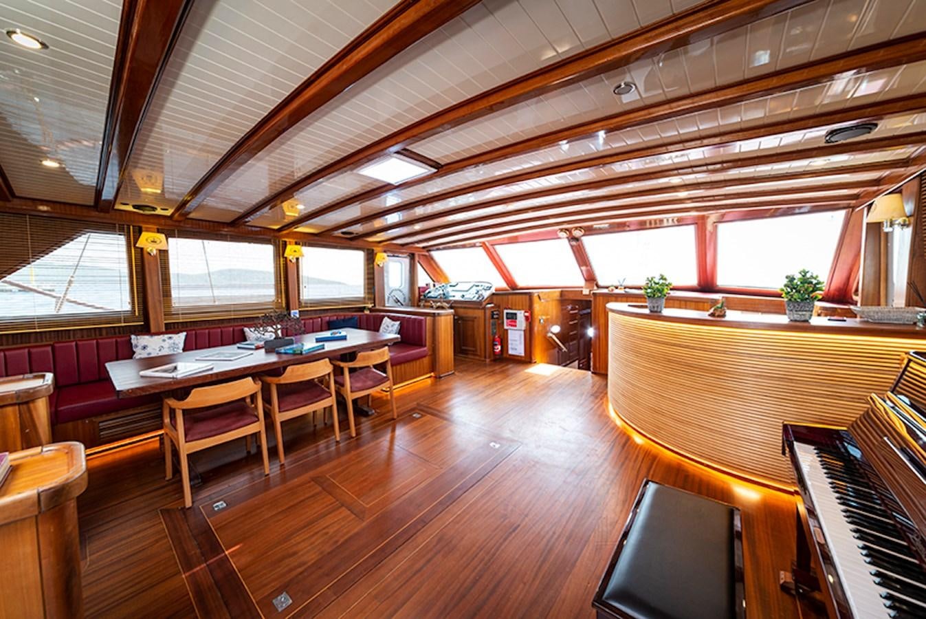 a room with tables and chairs aboard QUEEN OF DATCA Yacht for Sale