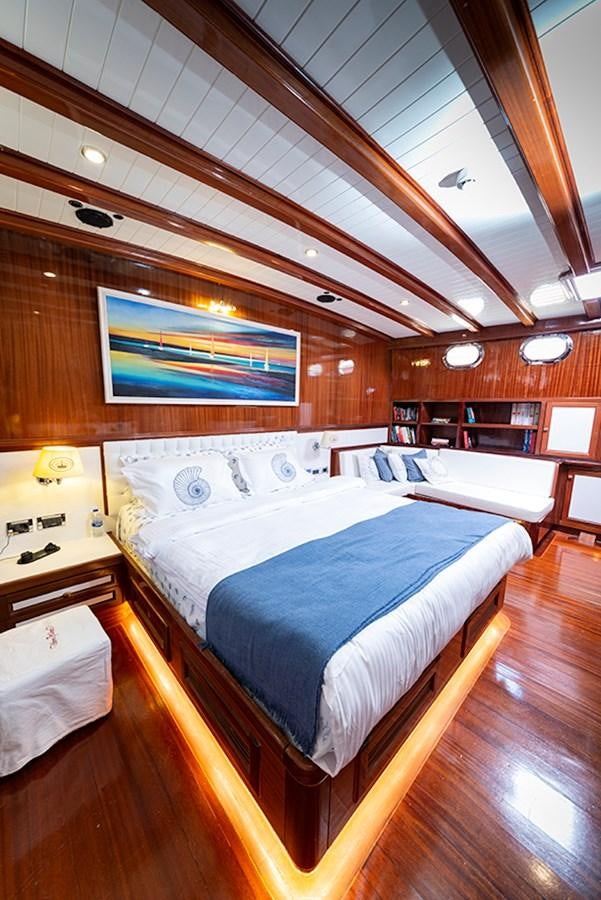 a room with a bed and a table aboard QUEEN OF DATCA Yacht for Sale