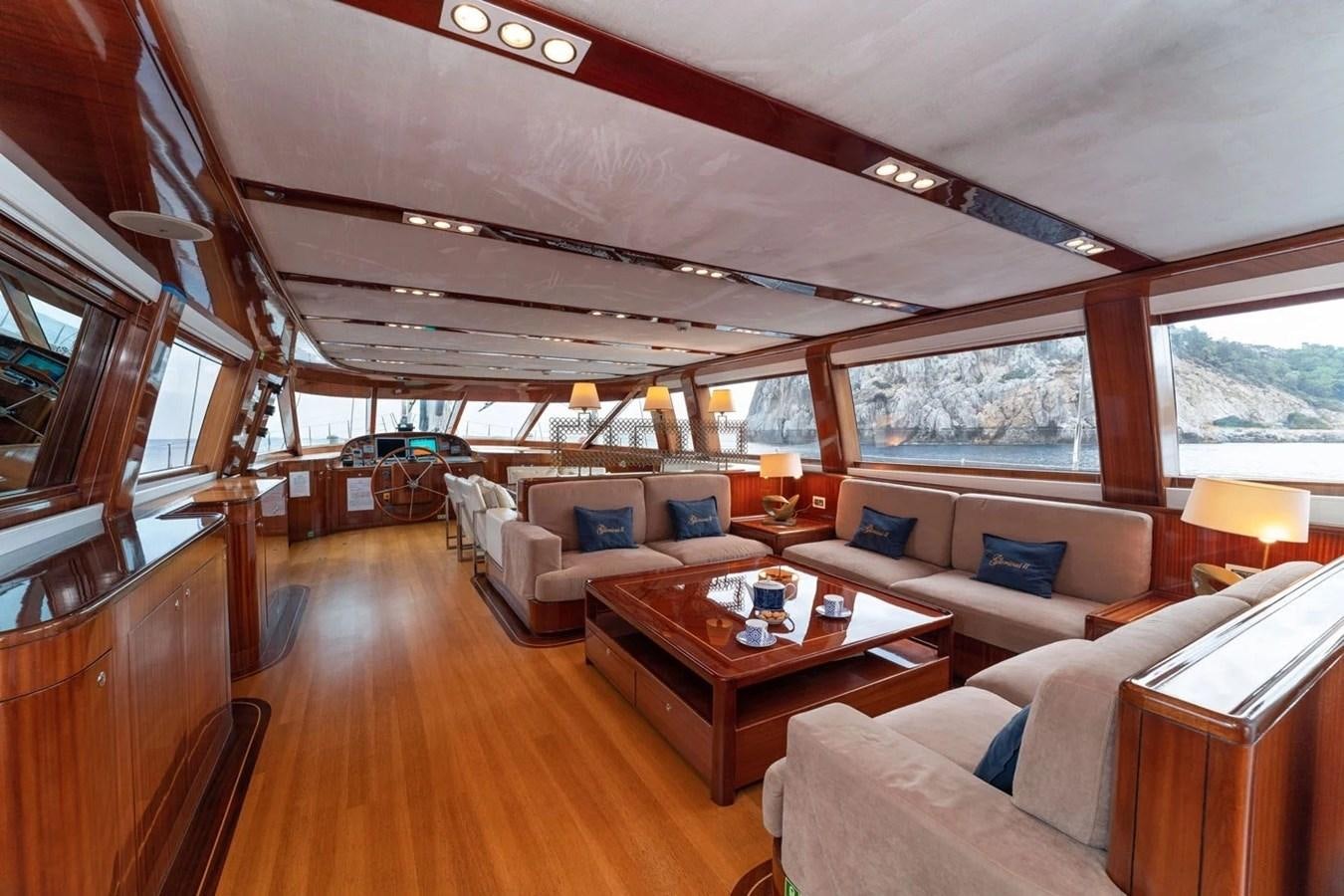 a living room with a large window aboard CUSTOM MOTORSAILOR Yacht for Sale