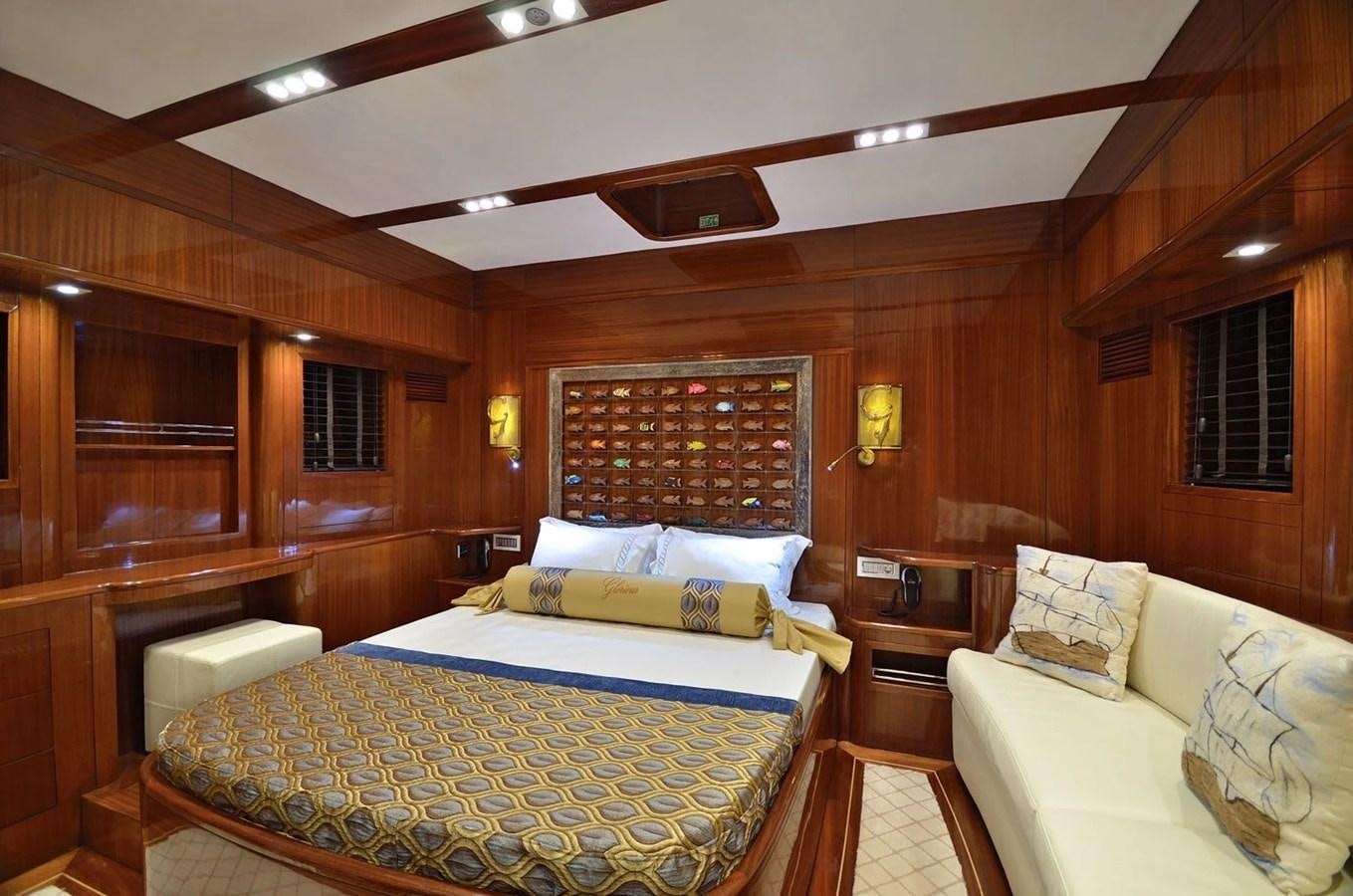 a room with a bed and a couch aboard CUSTOM MOTORSAILOR Yacht for Sale