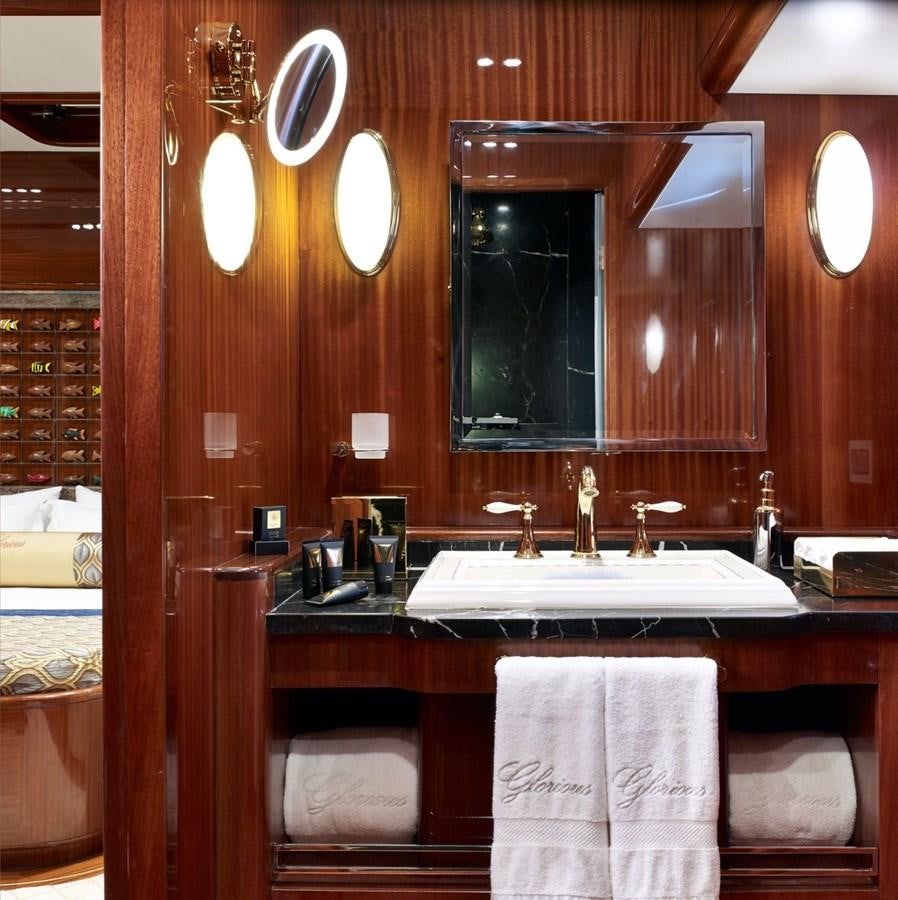 a bathroom with a large mirror aboard CUSTOM MOTORSAILOR Yacht for Sale