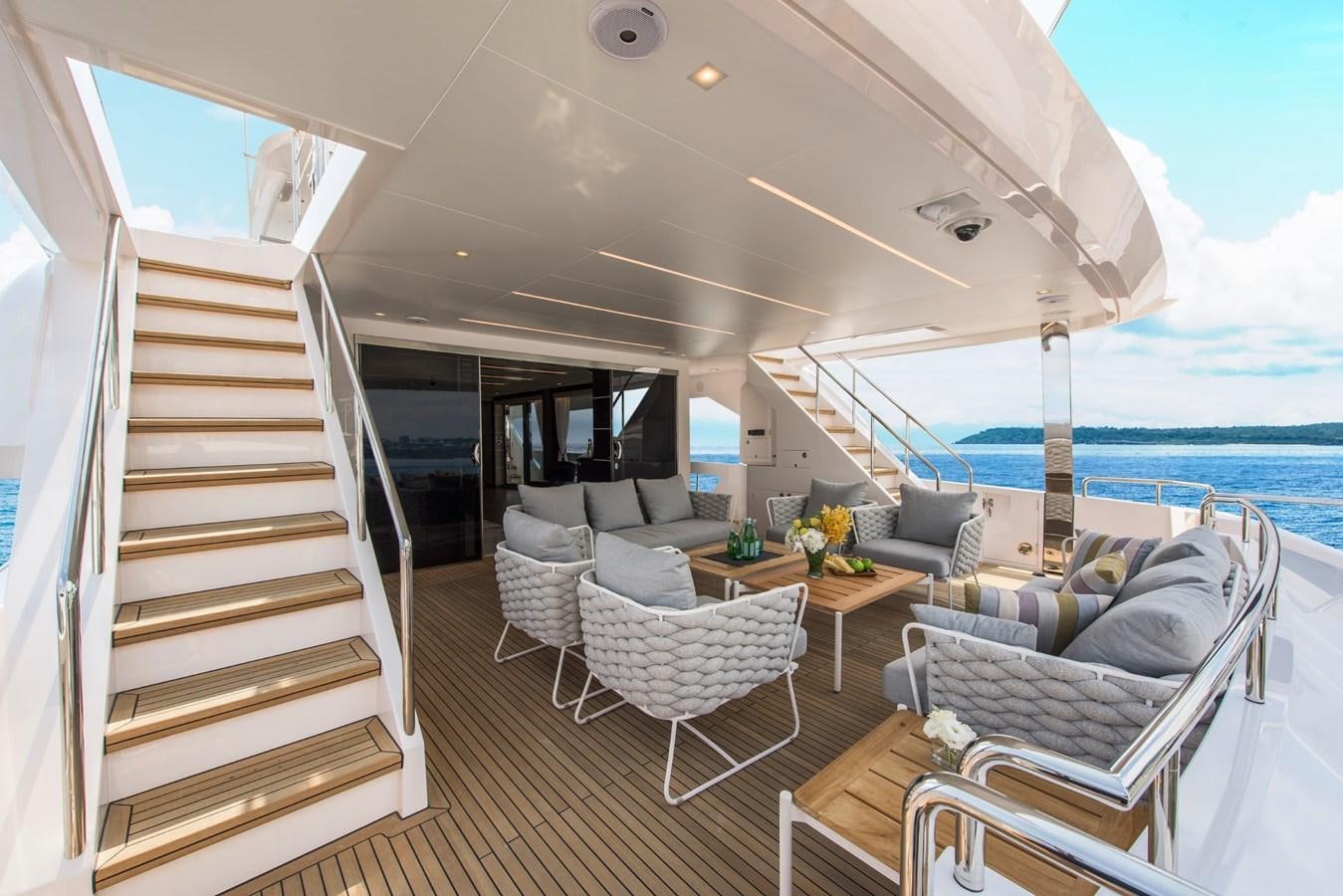 a room with a couch and a table and a view of the ocean aboard HORIZON Yacht for Sale