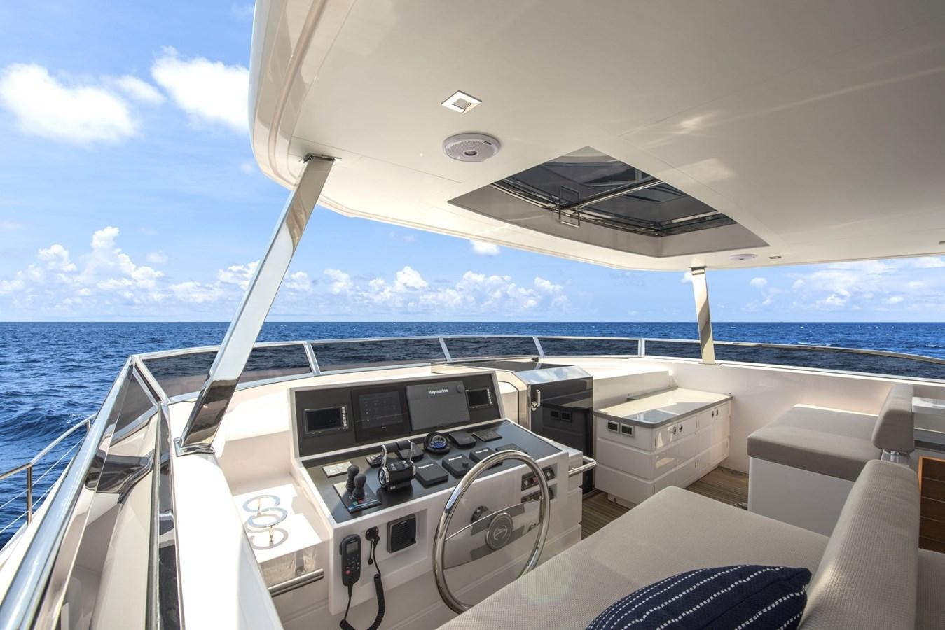 a boat with a deck and a view of the water aboard HORIZON Yacht for Sale